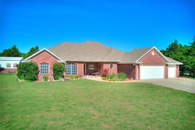 407 Heather Ln, Tuttle, OK 73089 - view of front of home with an attached garage, brick siding, concrete driveway, and a front yard