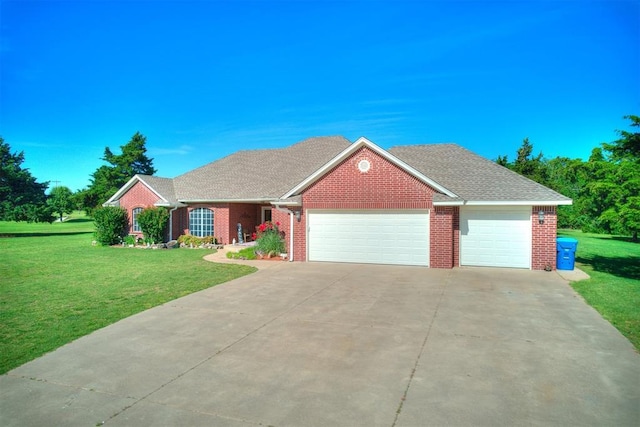 407 Heather Ln, Tuttle, OK 73089 - view of front of home with an attached garage, a front yard, brick siding, and concrete driveway