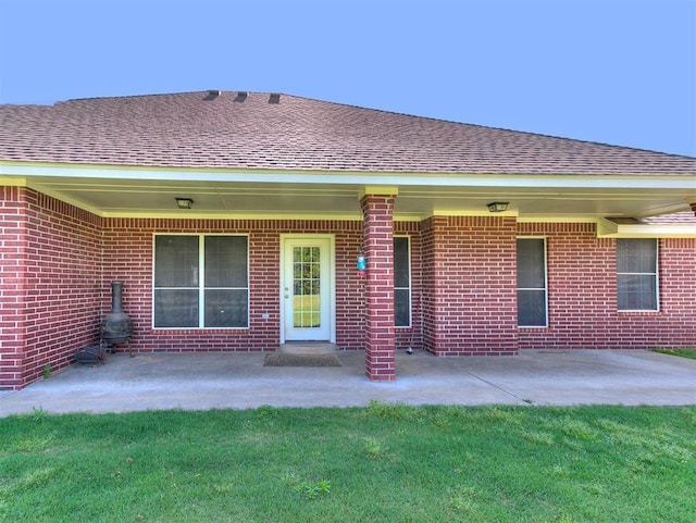 407 Heather Ln, Tuttle, OK 73089 - rear view of property with brick siding, roof with shingles, and a patio