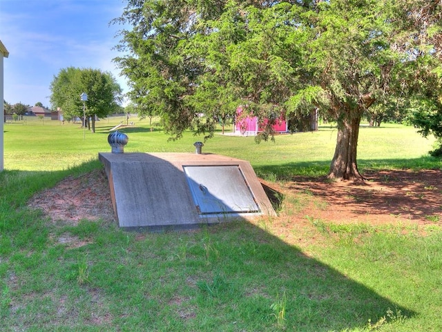 407 Heather Ln, Tuttle, OK 73089 - entry to storm shelter featuring a lawn