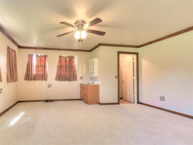 407 Heather Ln, Tuttle, OK 73089 - unfurnished bedroom with baseboards, light colored carpet, crown molding, and a ceiling fan