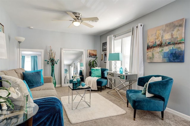interior space featuring visible vents, baseboards, and ceiling fan