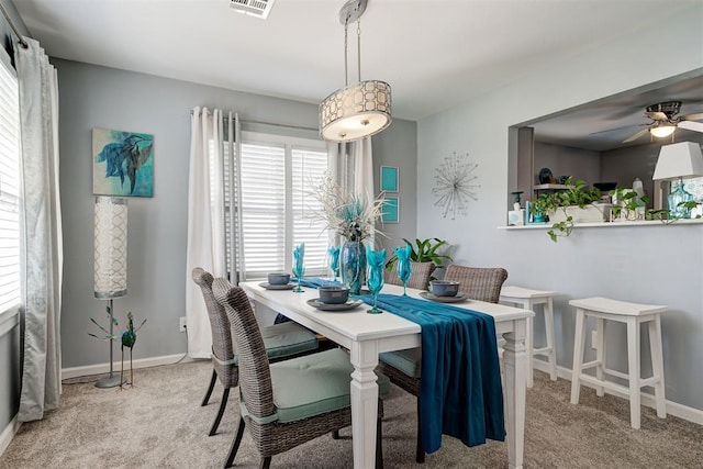 dining area with carpet floors, ceiling fan, and baseboards
