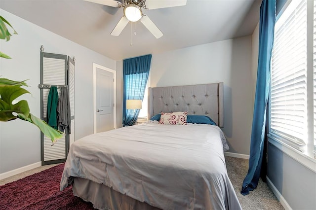 bedroom featuring baseboards, ceiling fan, and carpet