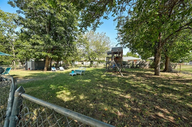 view of yard featuring fence and a playground