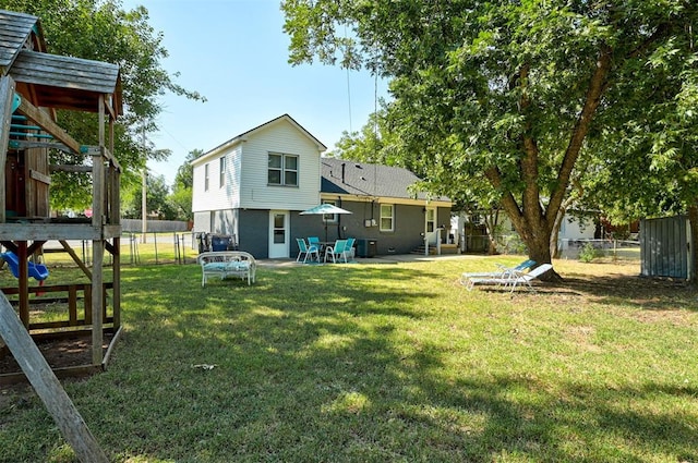 rear view of house with a yard, a gate, fence, and a patio