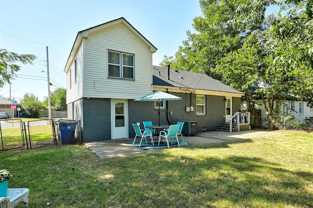 rear view of property featuring cooling unit, a yard, a gate, fence, and brick siding