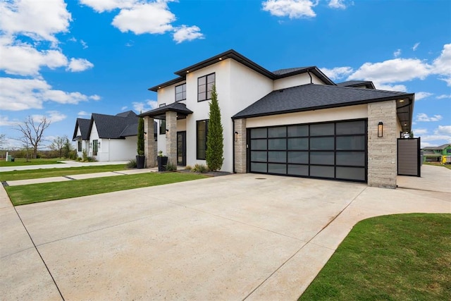 2109 Wiregrass Rd, Edmond, OK 73025 - contemporary house featuring driveway, stucco siding, an attached garage, stone siding, and a front yard