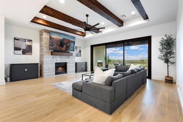 2109 Wiregrass Rd, Edmond, OK 73025 - living area with a ceiling fan, light wood-style floors, a fireplace, beamed ceiling, and recessed lighting