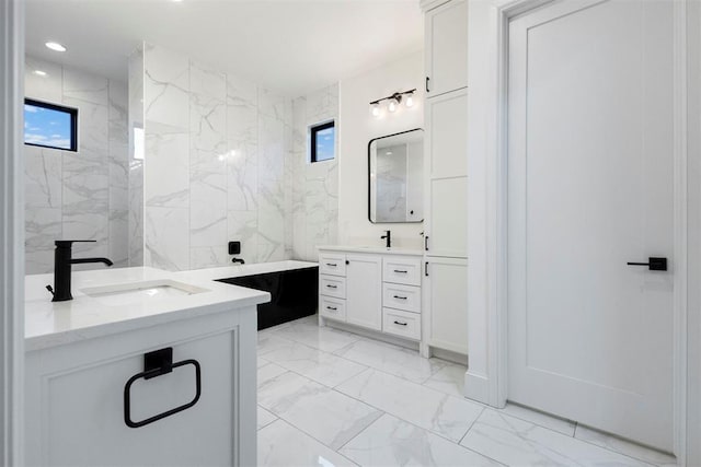2109 Wiregrass Rd, Edmond, OK 73025 - full bath featuring marble finish floors, two vanities, recessed lighting, and a tub to relax in