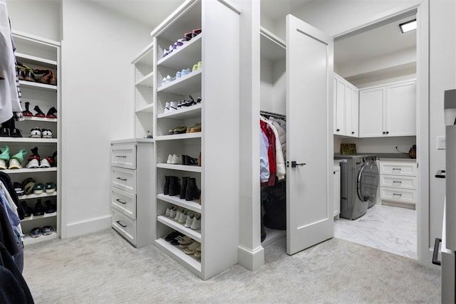 2109 Wiregrass Rd, Edmond, OK 73025 - spacious closet featuring light carpet and washing machine and clothes dryer