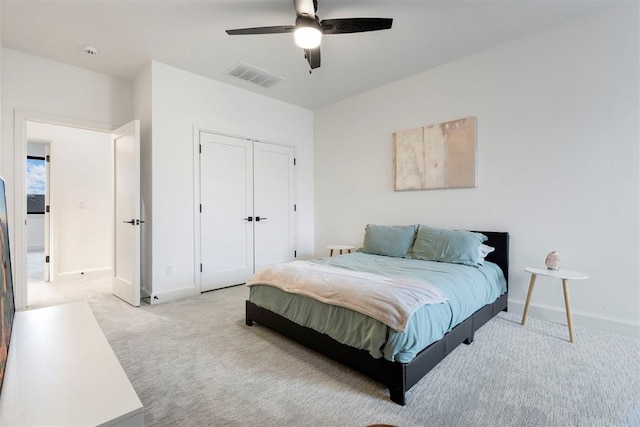 2109 Wiregrass Rd, Edmond, OK 73025 - bedroom with light carpet, a closet, and a ceiling fan