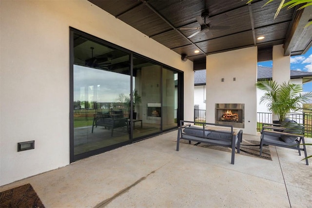 2109 Wiregrass Rd, Edmond, OK 73025 - view of patio featuring a warm lit fireplace and ceiling fan