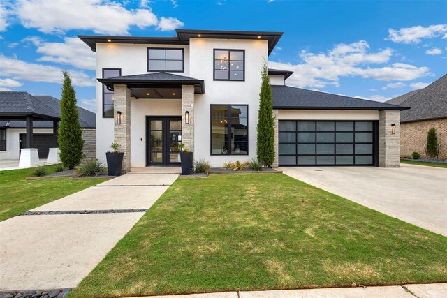 2109 Wiregrass Rd, Edmond, OK 73025 - contemporary home with french doors, stucco siding, stone siding, driveway, and a front lawn