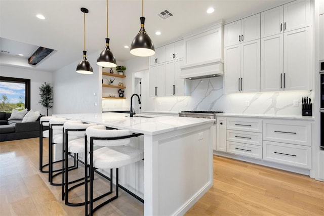 2109 Wiregrass Rd, Edmond, OK 73025 - kitchen featuring light wood-style floors, backsplash, white cabinets, and recessed lighting