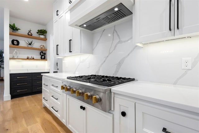 2109 Wiregrass Rd, Edmond, OK 73025 - kitchen featuring custom exhaust hood, open shelves, white cabinets, stainless steel gas stovetop, and light wood-style flooring