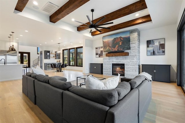 2109 Wiregrass Rd, Edmond, OK 73025 - living area featuring light wood finished floors, healthy amount of natural light, a ceiling fan, recessed lighting, and beamed ceiling