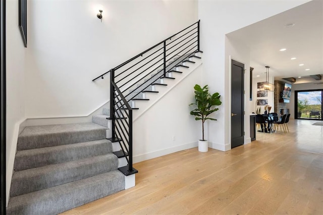 2109 Wiregrass Rd, Edmond, OK 73025 - stairs with wood finished floors and recessed lighting