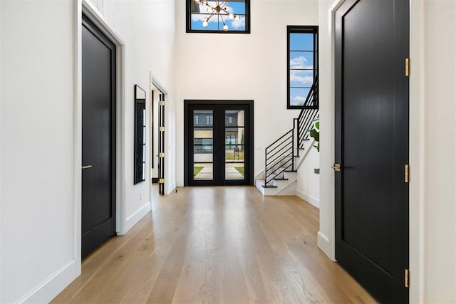 2109 Wiregrass Rd, Edmond, OK 73025 - entrance foyer featuring healthy amount of natural light, light wood-style flooring, stairway, and a towering ceiling