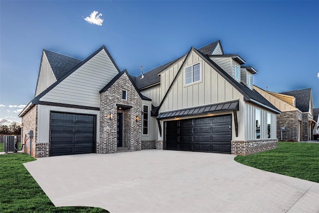 modern farmhouse style home featuring driveway, a front yard, brick siding, board and batten siding, and metal roof