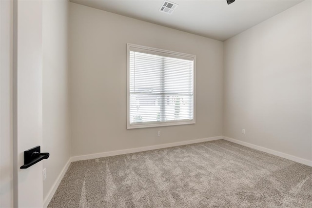 unfurnished room with carpet and baseboards