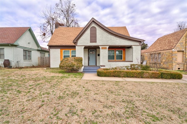 2765 NW 20th St, Oklahoma City, OK 73107 - view of front of property with brick siding, a front yard, and roof with shingles