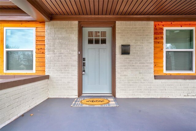 2765 NW 20th St, Oklahoma City, OK 73107 - doorway to property featuring brick siding and a porch