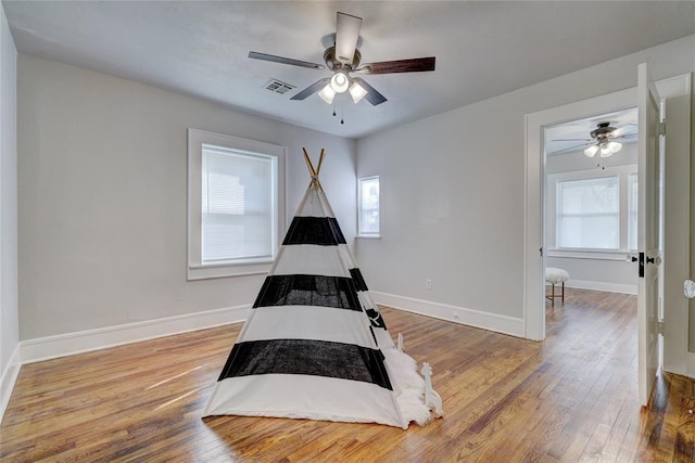 2765 NW 20th St, Oklahoma City, OK 73107 - bedroom featuring hardwood / wood-style floors, baseboards, ceiling fan, and visible vents