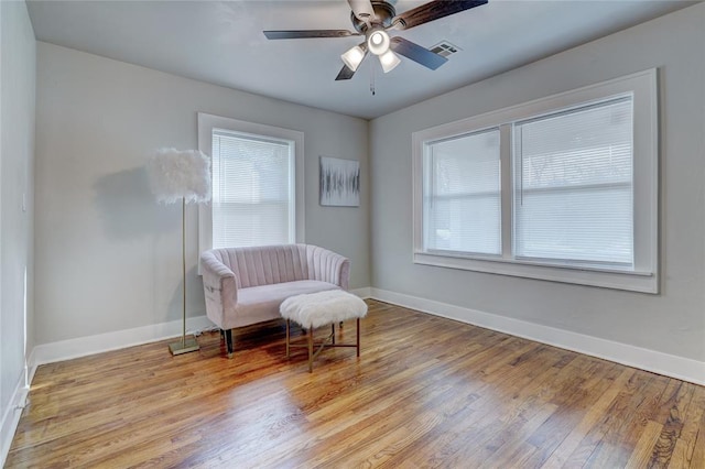 2765 NW 20th St, Oklahoma City, OK 73107 - living area with baseboards, a ceiling fan, and hardwood / wood-style flooring