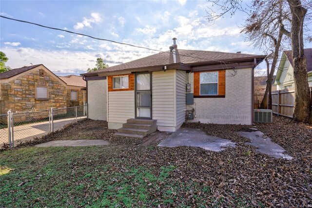 2765 NW 20th St, Oklahoma City, OK 73107 - back of property featuring a fenced backyard, entry steps, and brick siding