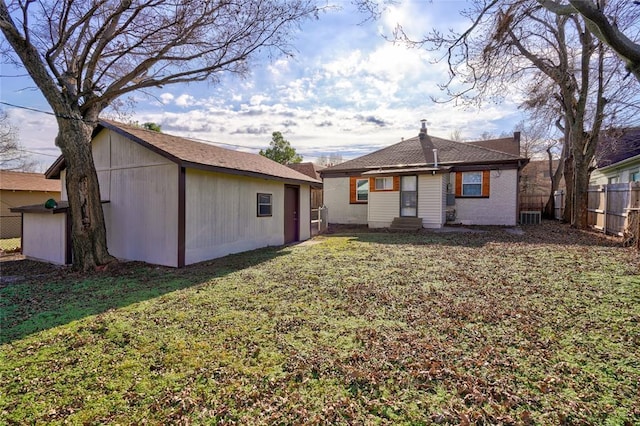 2765 NW 20th St, Oklahoma City, OK 73107 - back of property with a lawn, entry steps, and fence