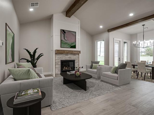 15216 Bedford Rd, Edmond, OK 73013 - living room featuring light wood finished floors, visible vents, a notable chandelier, vaulted ceiling with beams, and a fireplace