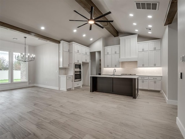 15216 Bedford Rd, Edmond, OK 73013 - kitchen with decorative backsplash, visible vents, stainless steel appliances, a sink, and ceiling fan with notable chandelier