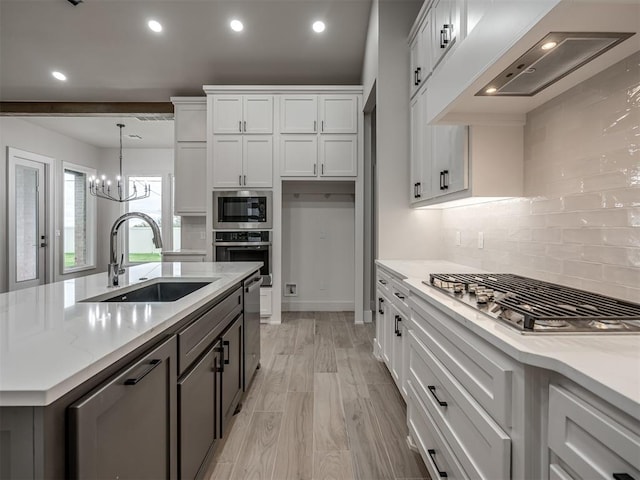 15216 Bedford Rd, Edmond, OK 73013 - kitchen with stainless steel appliances, white cabinetry, a sink, custom range hood, and backsplash