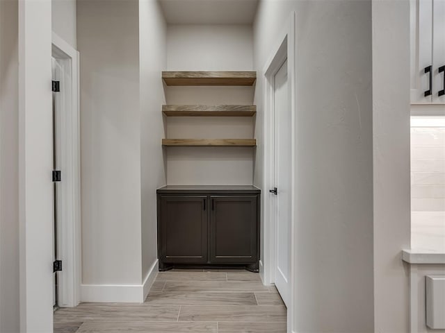 15216 Bedford Rd, Edmond, OK 73013 - corridor featuring baseboards and light wood-style flooring