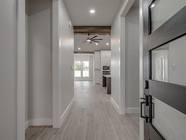 15216 Bedford Rd, Edmond, OK 73013 - hallway with baseboards, recessed lighting, light wood-type flooring, and beam ceiling