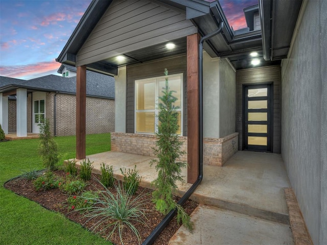 15216 Bedford Rd, Edmond, OK 73013 - exterior entry at dusk with a yard
