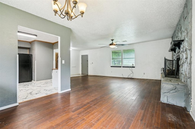 3206 Oakbriar Dr, Choctaw, OK 73020 - unfurnished living room with a chandelier, ceiling fan, hardwood / wood-style floors, a fireplace, and a textured ceiling