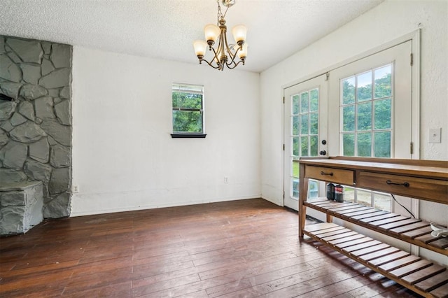3206 Oakbriar Dr, Choctaw, OK 73020 - unfurnished dining area featuring a chandelier, hardwood / wood-style flooring, and a textured ceiling