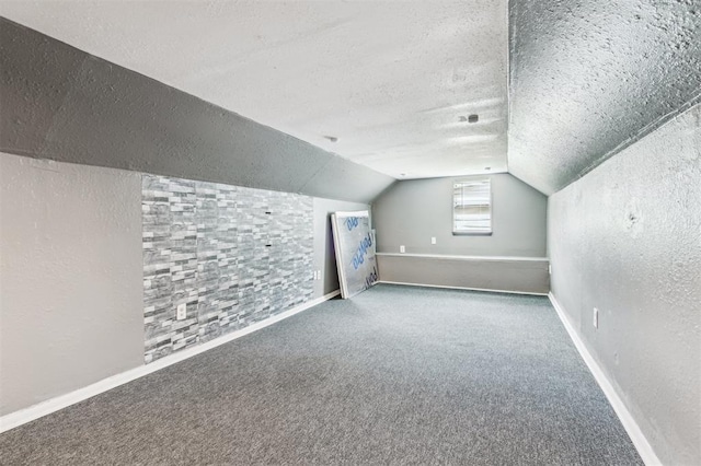 3206 Oakbriar Dr, Choctaw, OK 73020 - additional living space featuring a textured ceiling, lofted ceiling, carpet floors, baseboards, and a textured wall