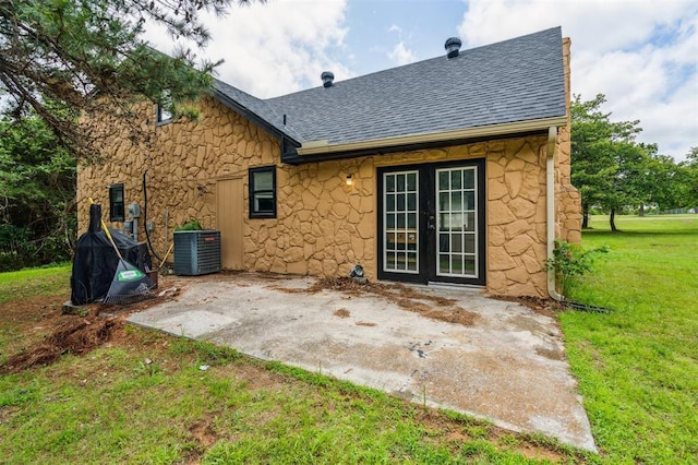 3206 Oakbriar Dr, Choctaw, OK 73020 - back of house featuring roof with shingles, a patio, a yard, and stone siding