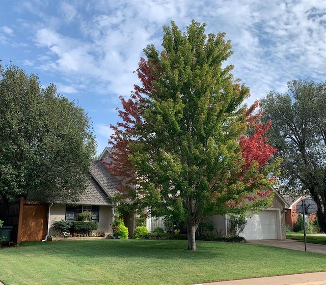 1309 Salem Ave, Edmond, OK 73003 - view of front of property with a front yard, driveway, and a garage