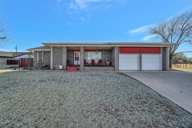 920 Sherwood, Clinton, OK 73601 - mid-century home with a porch, an attached garage, driveway, and brick siding