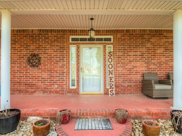 property entrance featuring brick siding