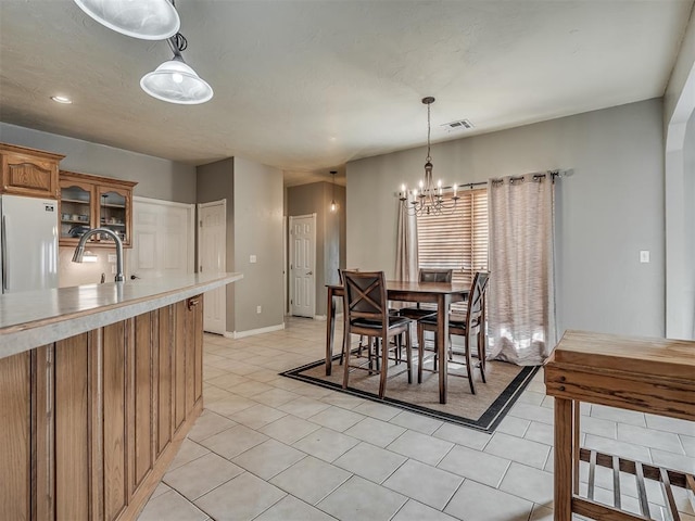 dining room with baseboards, a notable chandelier, visible vents, and light tile patterned flooring