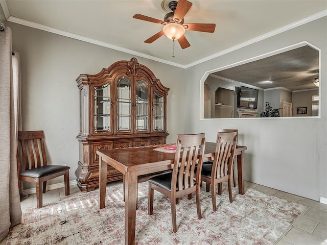 dining area with light tile patterned floors, ornamental molding, and ceiling fan