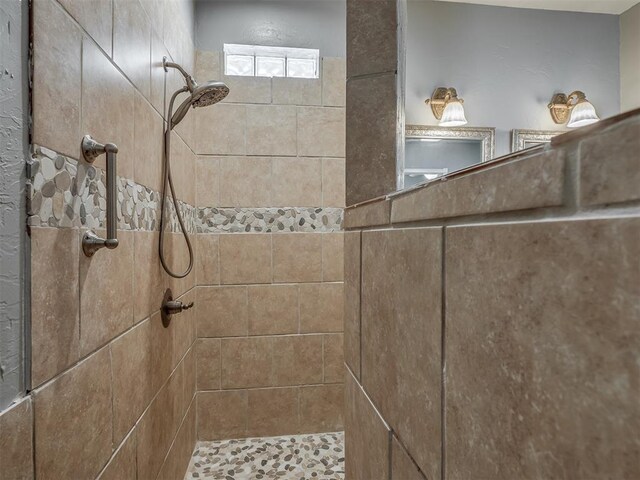 full bath featuring tiled shower
