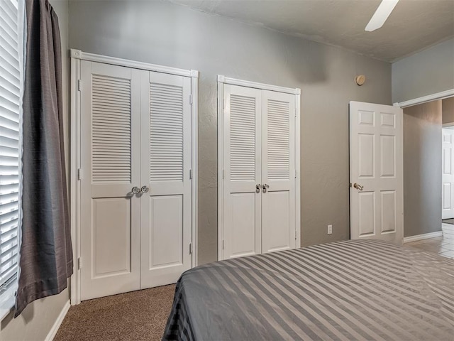 bedroom with multiple closets and ceiling fan