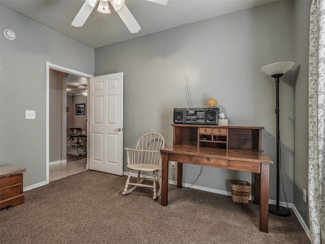 office area with carpet floors, a ceiling fan, and baseboards