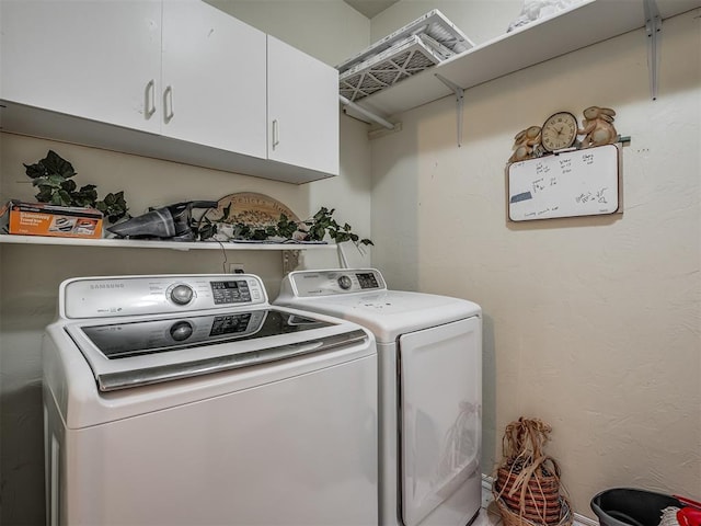 laundry room featuring washer and dryer and cabinet space